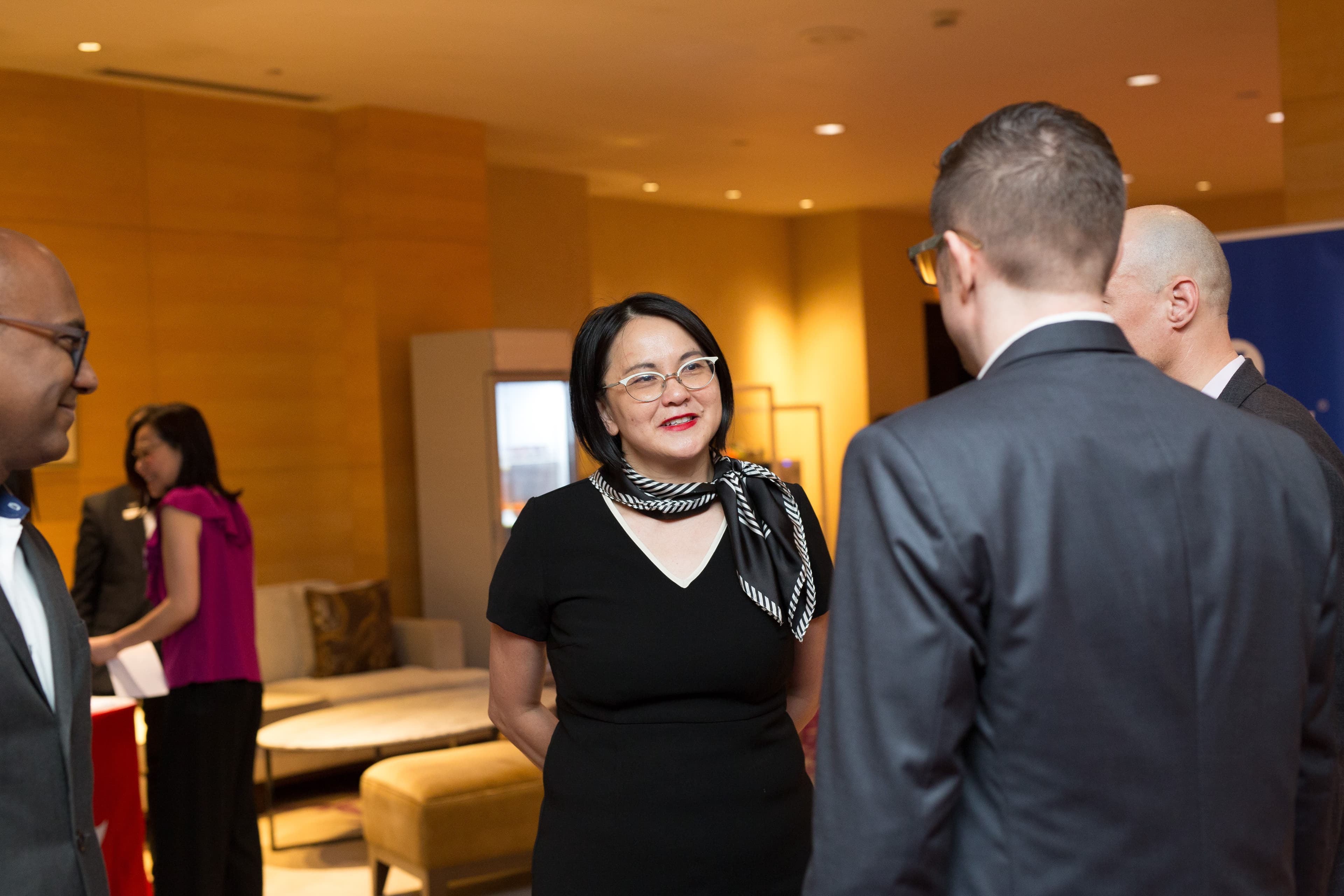 Evelyn Foong networking with colleagues at a Zurich event
